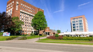 Un grand bâtiment en briques, doté de plusieurs étages et d’une entrée centrale.