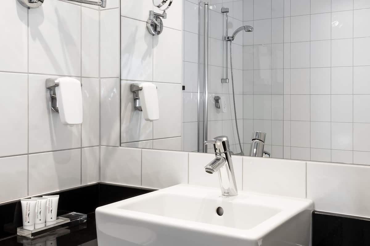 separate bathtub and shower, hair dryer, towels, soap