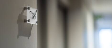A white sign with the number 738 attached to a wall.