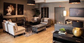 Relax in style with a sofa set, armchairs, and ottoman arranged around a central coffee table.