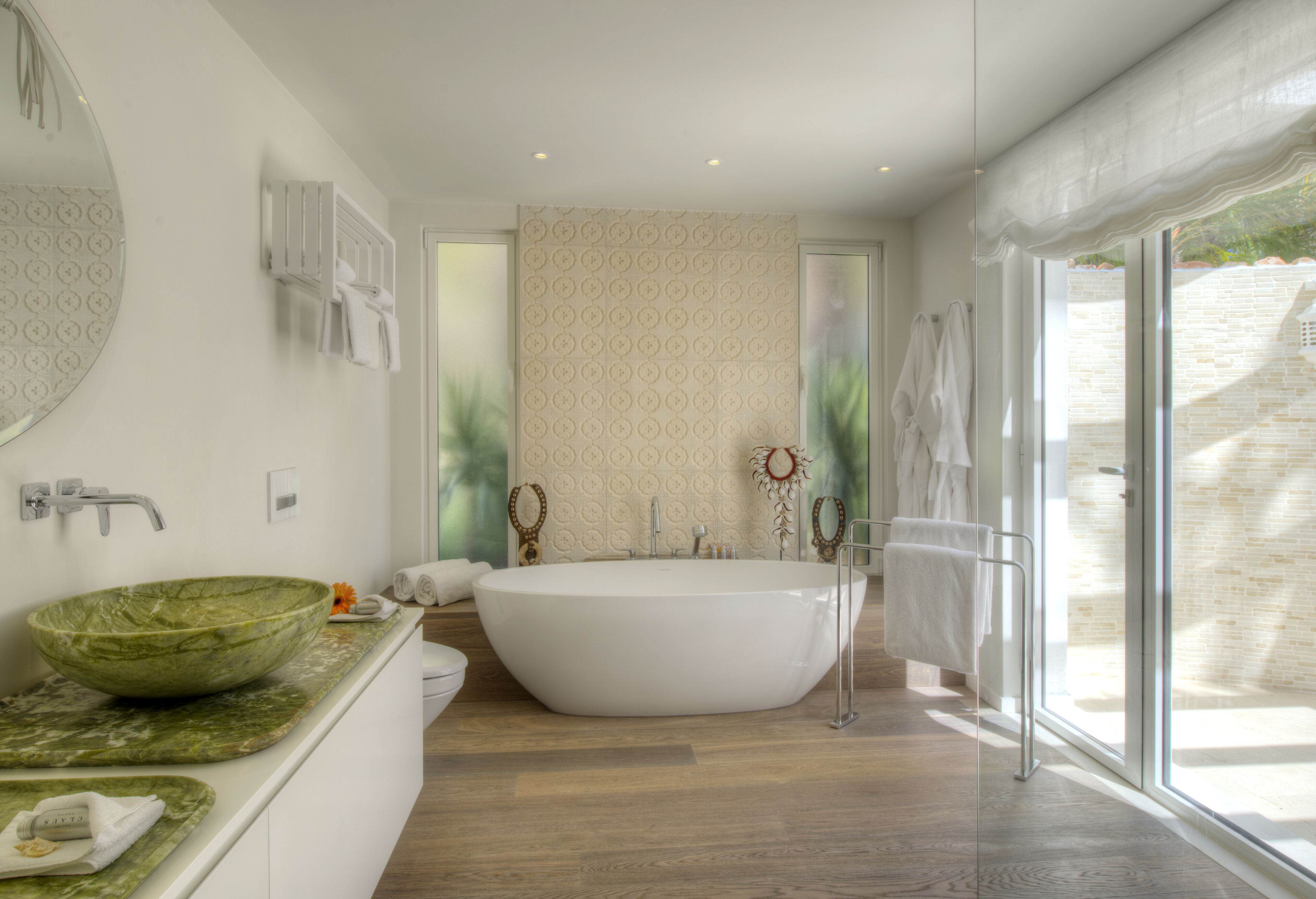 A modern bathroom with a freestanding bathtub, a large oval sink, and a glass shower enclosure.