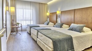 A hotel room with two beds, a desk, and a chair. - Hotel Cinquentenário & Conference Center (Ourem)