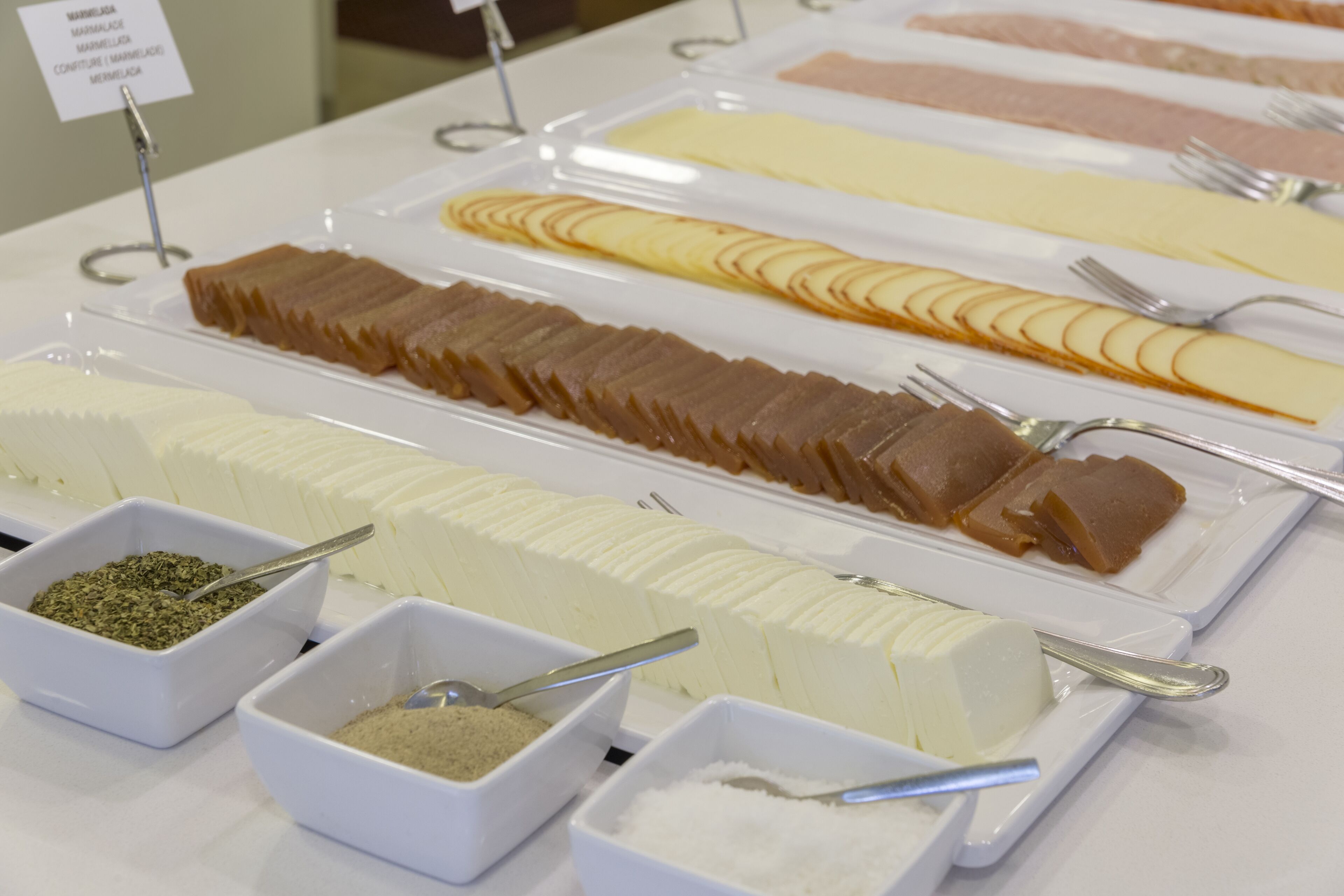 A buffet with various food items and condiments.