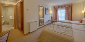 Triple Room | Minibar, in-room safe, individually furnished, desk