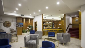 A modern lounge area with seating, a bar, and a staircase. - Casual Inca Porto Hotel by Casual Hoteles (Porto)