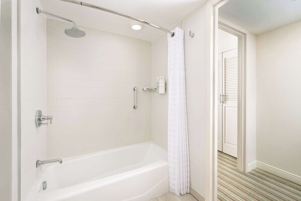 A modern bathroom with a walk-in shower, a bathtub, and a toilet. - Embassy Suites by Hilton San Juan Hotel & Casino (Carolina)
