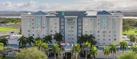 A multi-story hotel with a prominent sign reading "Embassy Suites San Juan Hotel & Casino".