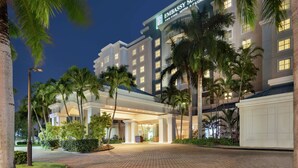 A modern hotel with a prominent sign reading "Embassy Suites." - Embassy Suites by Hilton San Juan Hotel & Casino (Carolina)