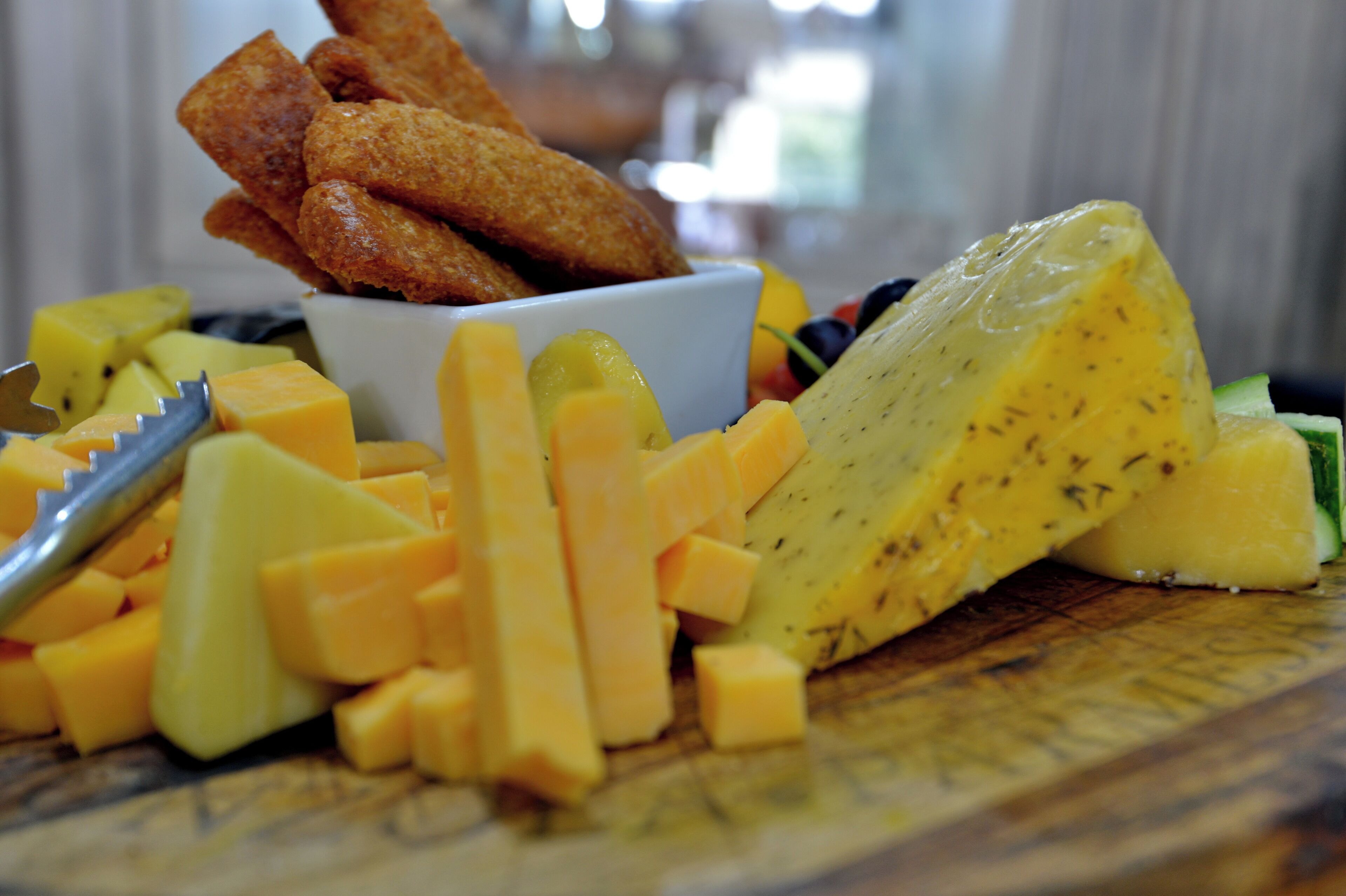 Eine Platte mit Käse, Mango und frittierten Speisen.