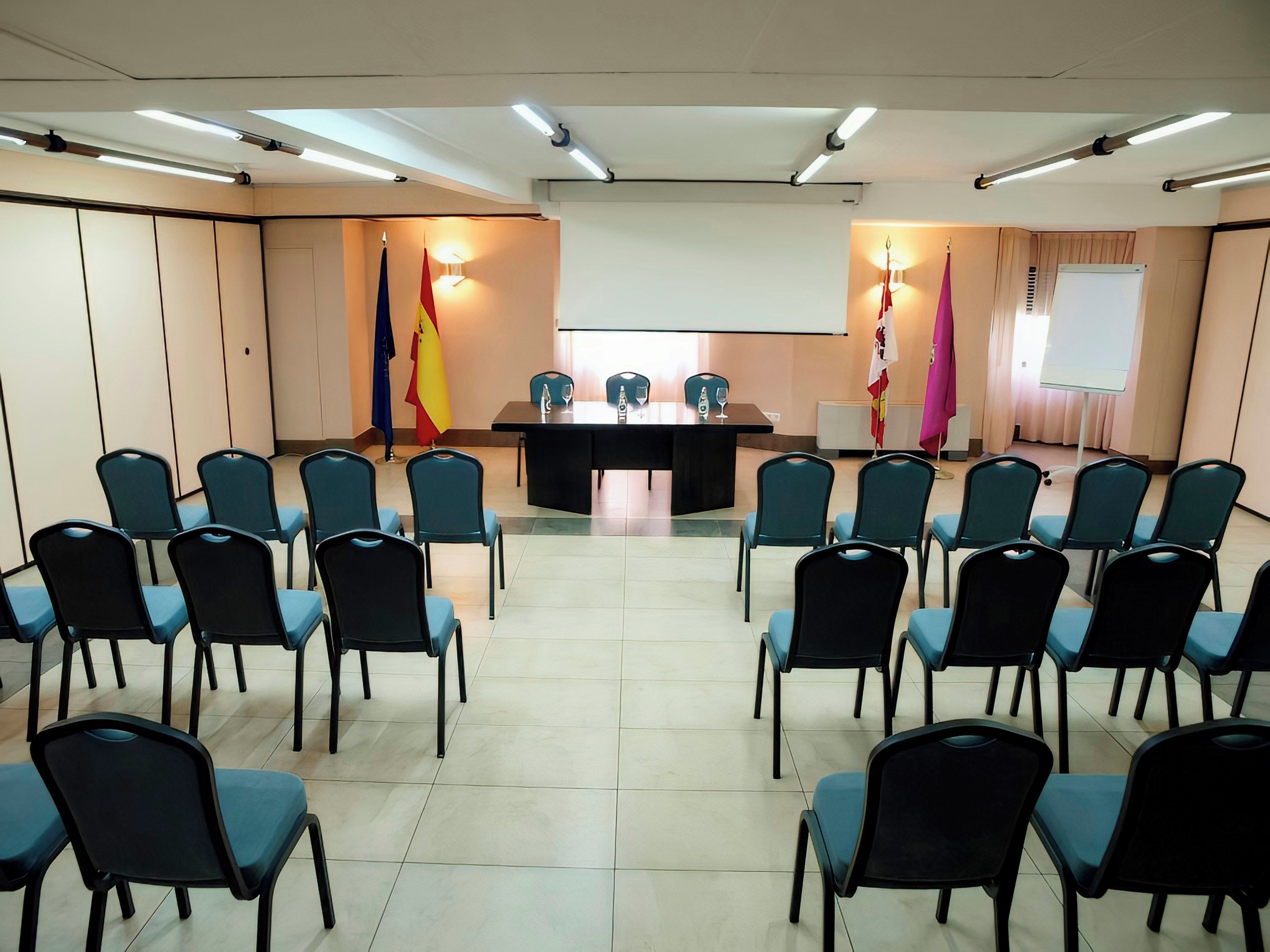 A conference room with a long table and chairs arranged for a meeting.