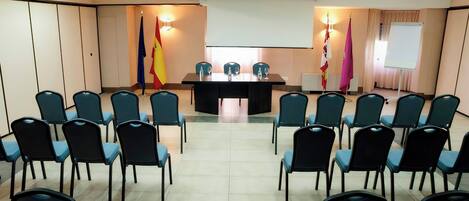 A conference room with a long table and chairs arranged for a meeting.