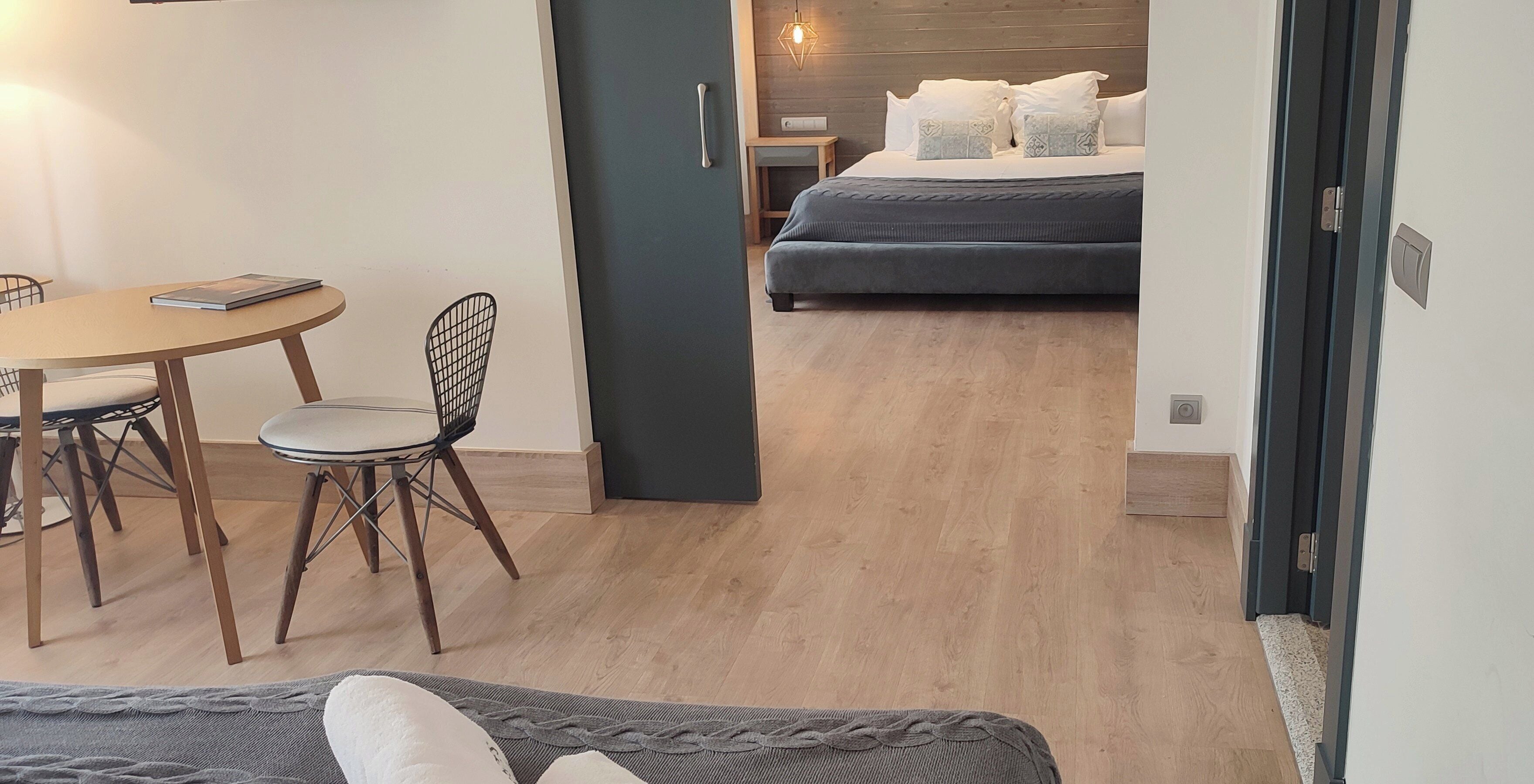 A room with a bed, a desk, and a chair.