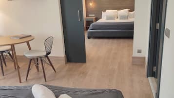 A room with a bed, a desk, and a chair.