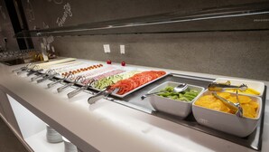 A buffet with various food items and utensils. - Hotel Turin  Barcelona  (Barcelona)