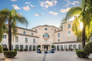 A building with a central entrance, arched windows, and a symmetrical facade.