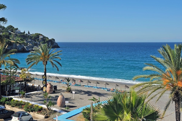 On the beach, sun loungers, beach umbrellas