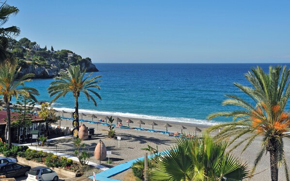 On the beach, sun-loungers, beach umbrellas