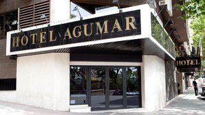 A hotel entrance with a sign reading 'HOTEL AGUMAR,' large glass doors, and a modern architectural design. - Hotel Agumar Atocha (Madrid)