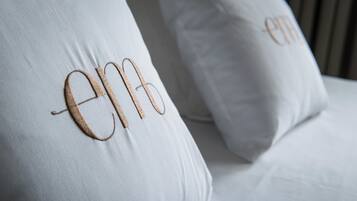 A close-up of two white pillows with embroidered text.