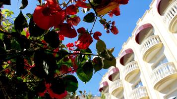 A building with balconies and a clear blue sky.