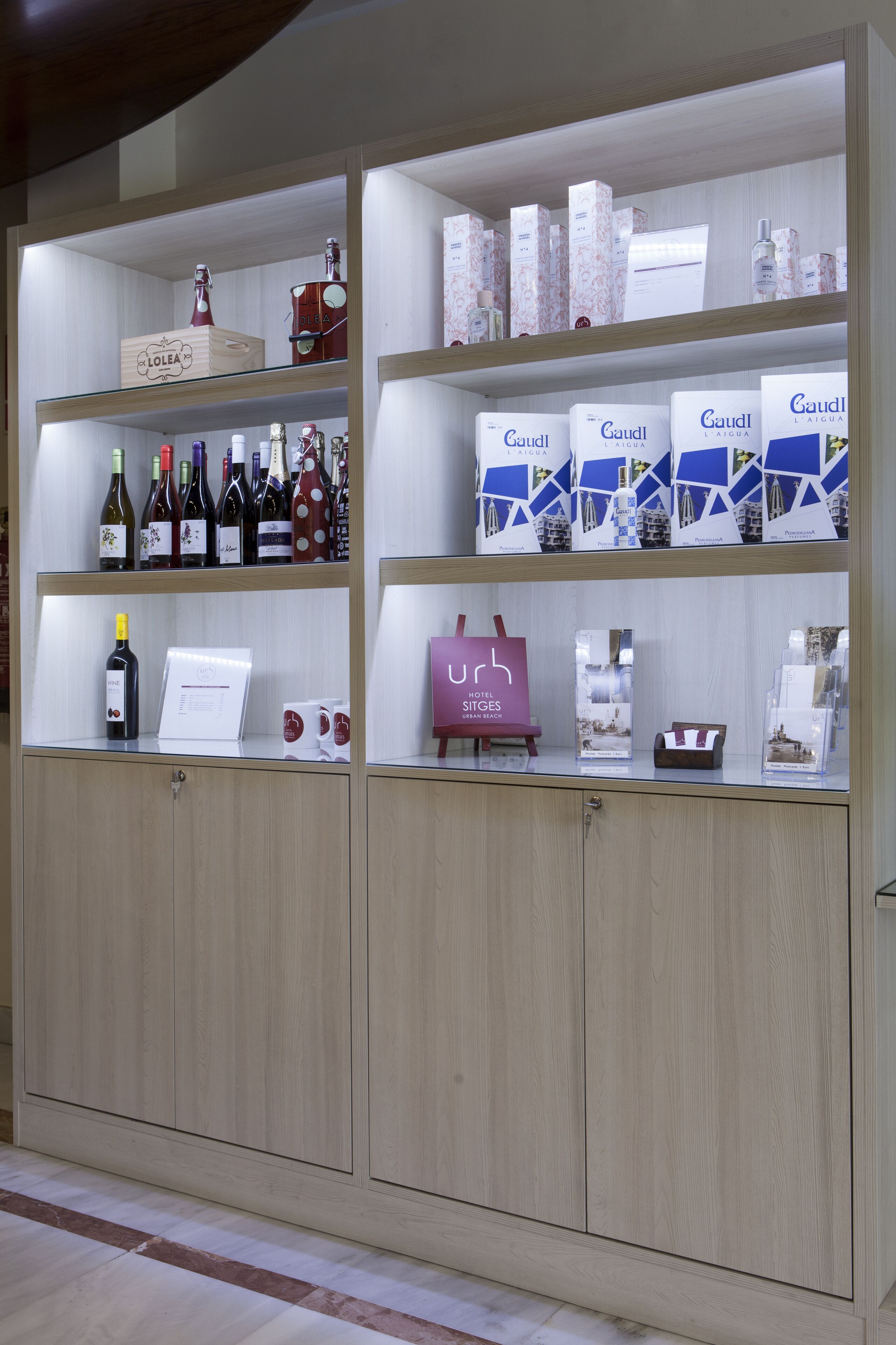 A hotel reception area with wooden cabinets displaying various items.