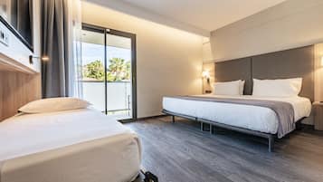 Triple Room, Multiple Beds, City View | Down comforters, minibar, desk, blackout drapes