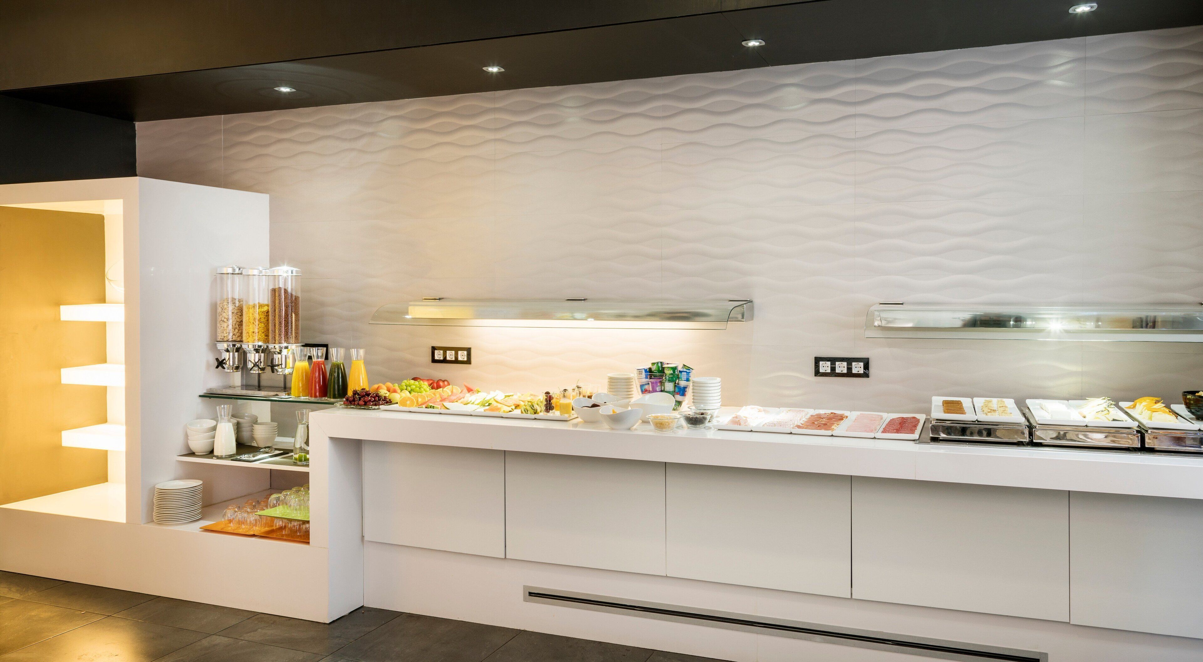A buffet setup with various food items and beverages.