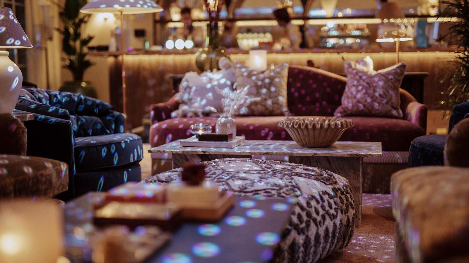 A cozy lounge area with plush seating, a coffee table, and ambient lighting.
