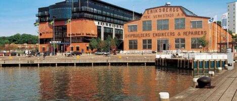 A waterfront building with a sign for 'Erik Bergs Shipbuilders Engineers & Repairers'.