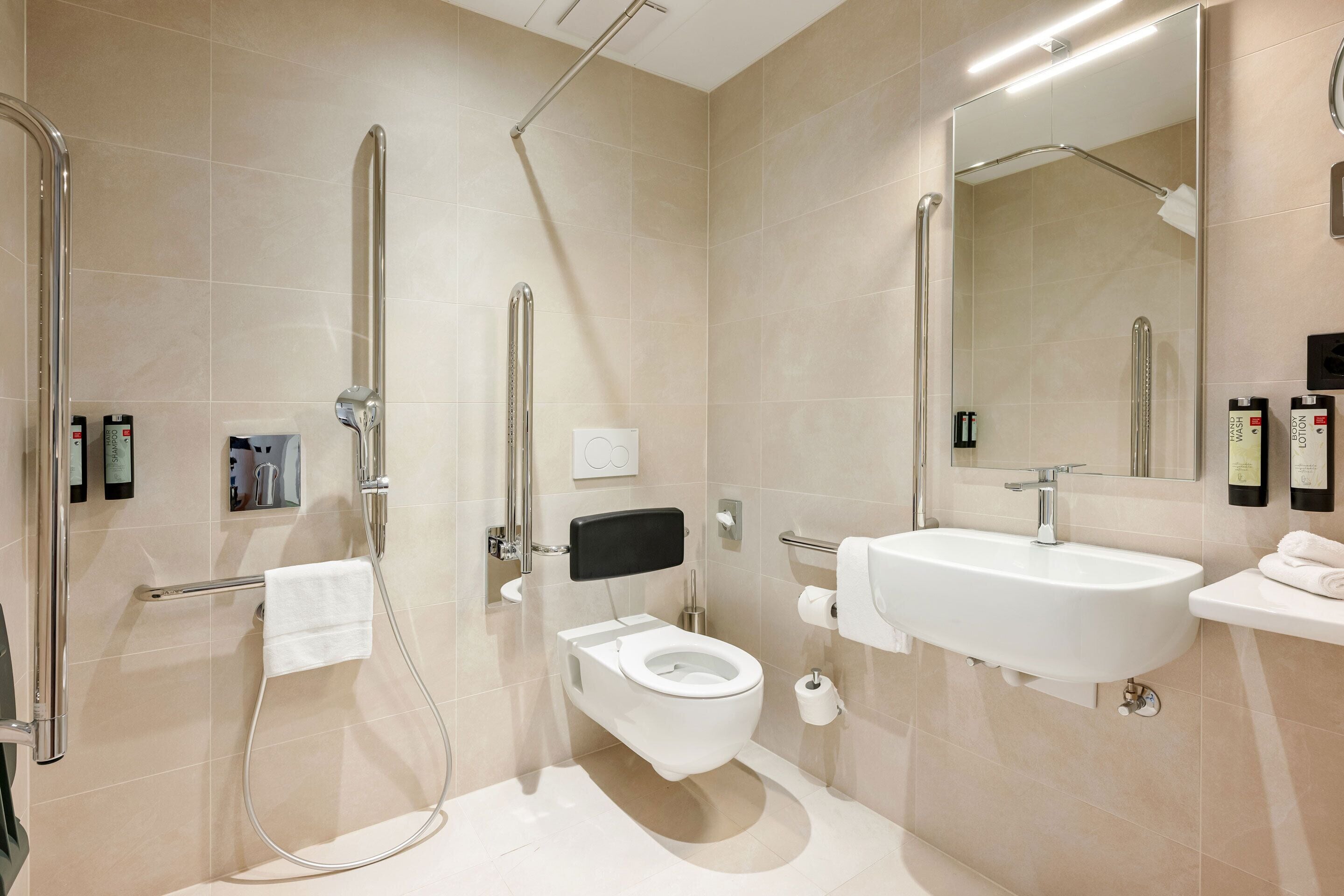 A modern bathroom with a walk-in shower, toilet, and sink.