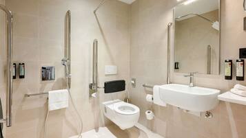 A modern bathroom with a walk-in shower, toilet, and sink.