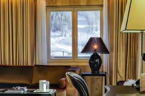 Relax in a serene setting with a view of snow-covered trees and a peaceful path.