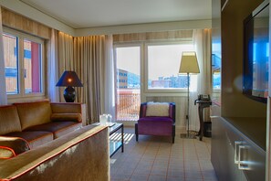 Relax in this stylish room with a comfortable sofa, armchair, and large flat-screen TV.