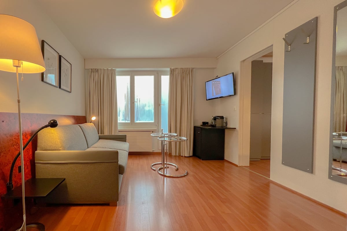 Family Suite, Balcony | Living area | 32-inch LCD TV with cable channels, TV