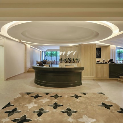 A spa and fitness center area with a reception desk, a patterned carpet, and a view of the outdoors.