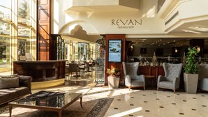 A spacious lobby with a reception desk, seating area, and a sign for 'Revan restaurant'. - Eresin Hotels Topkapi (Istanbul)