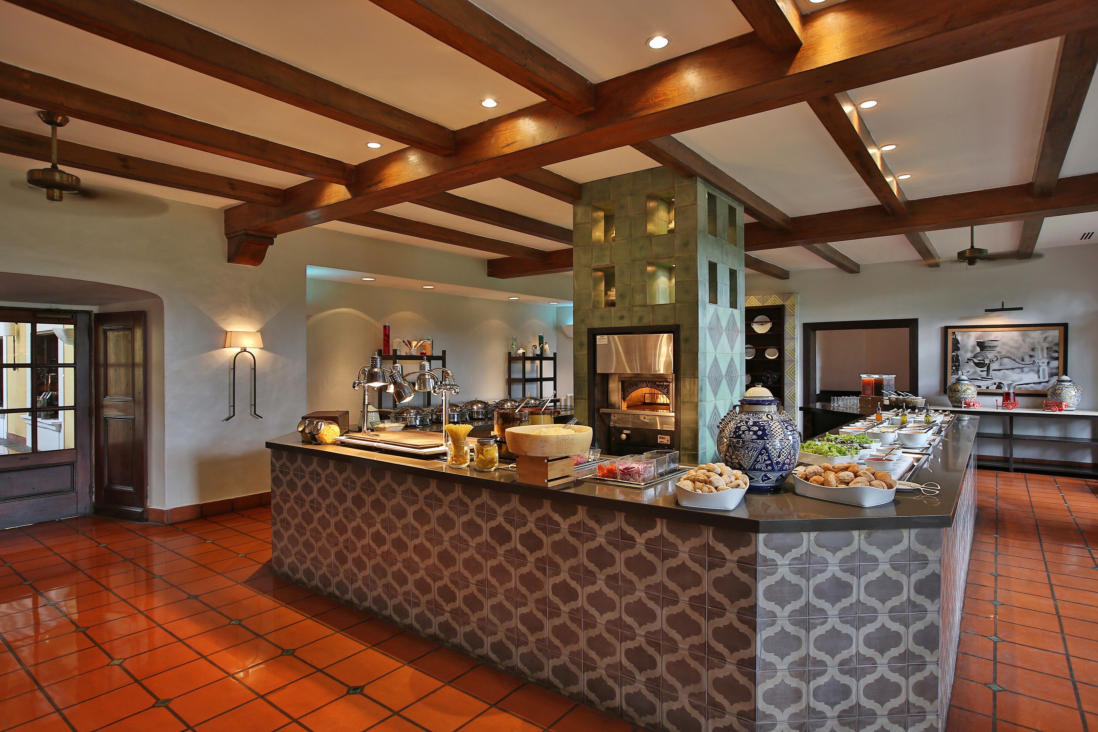 A breakfast bar with various food items and a coffee station.