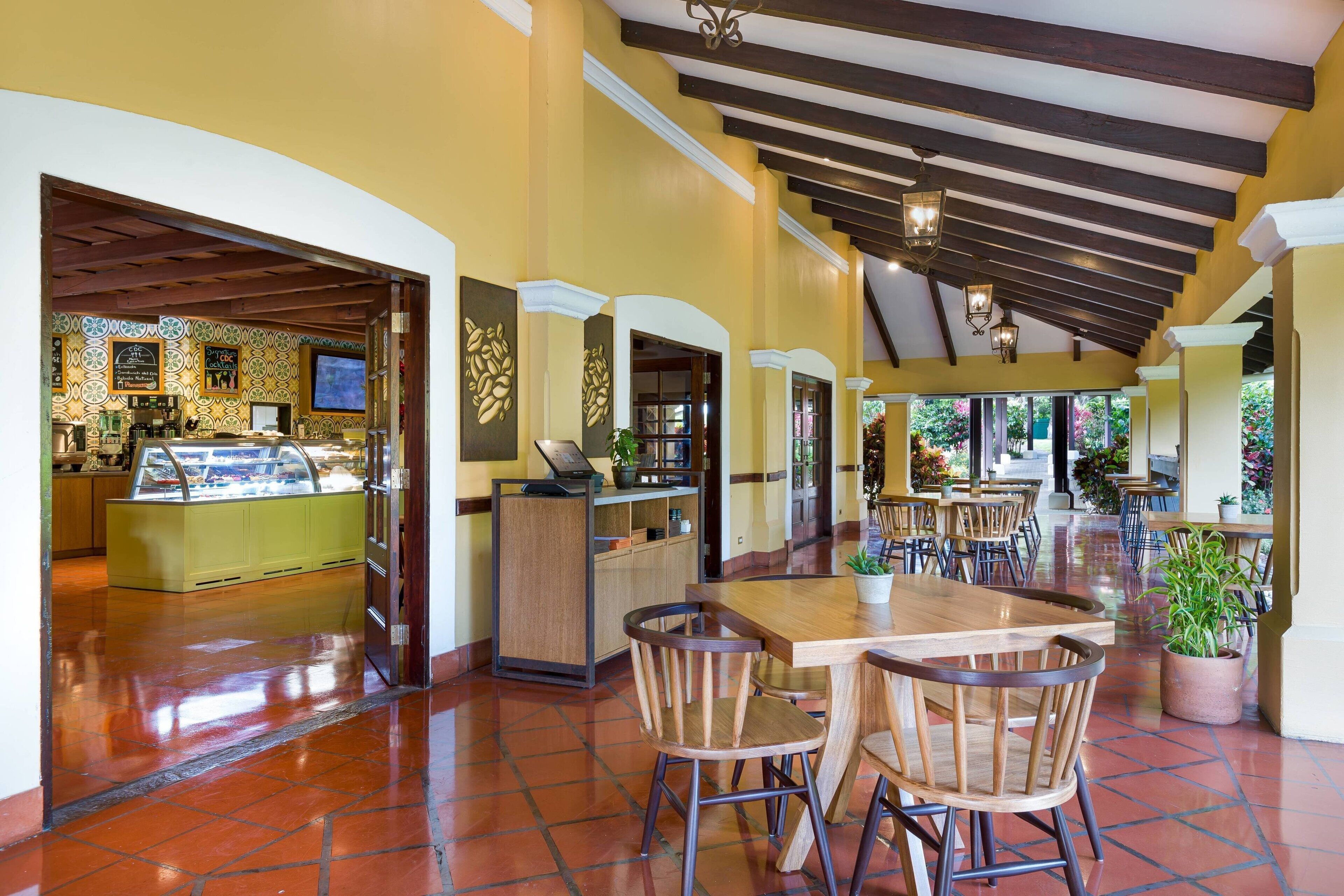 A spacious indoor area with a central seating area, a counter, and a display case.