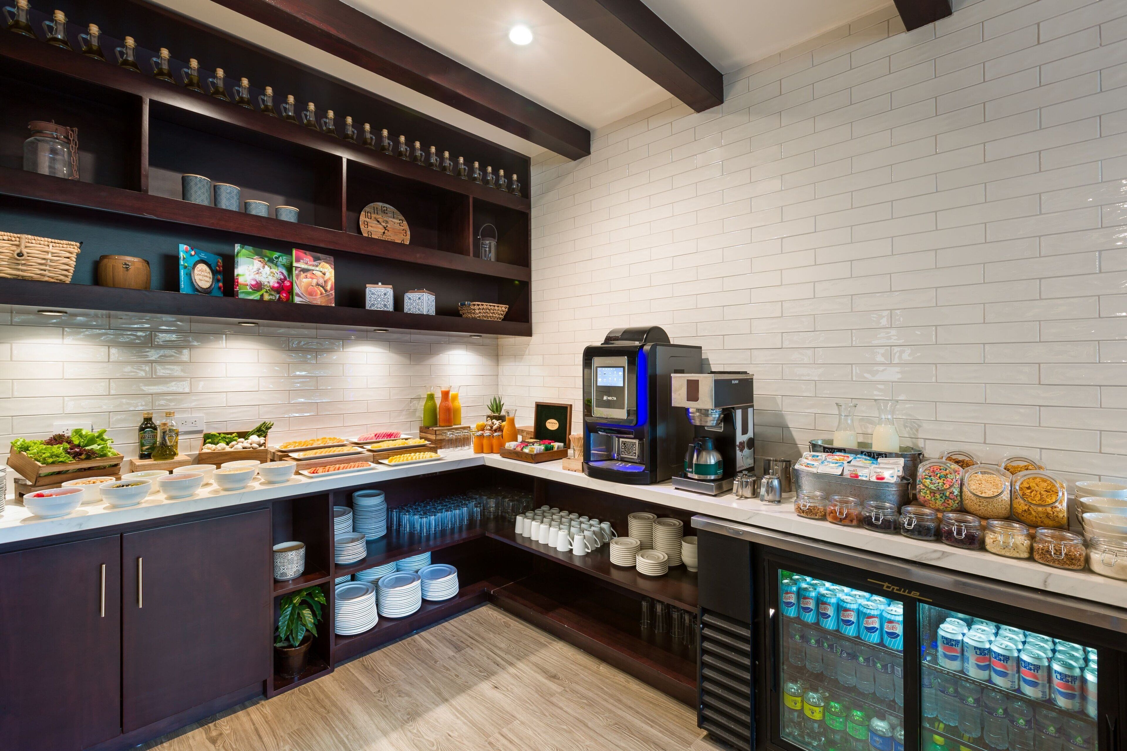A well-organized buffet area with various food items, beverages, and condiments.