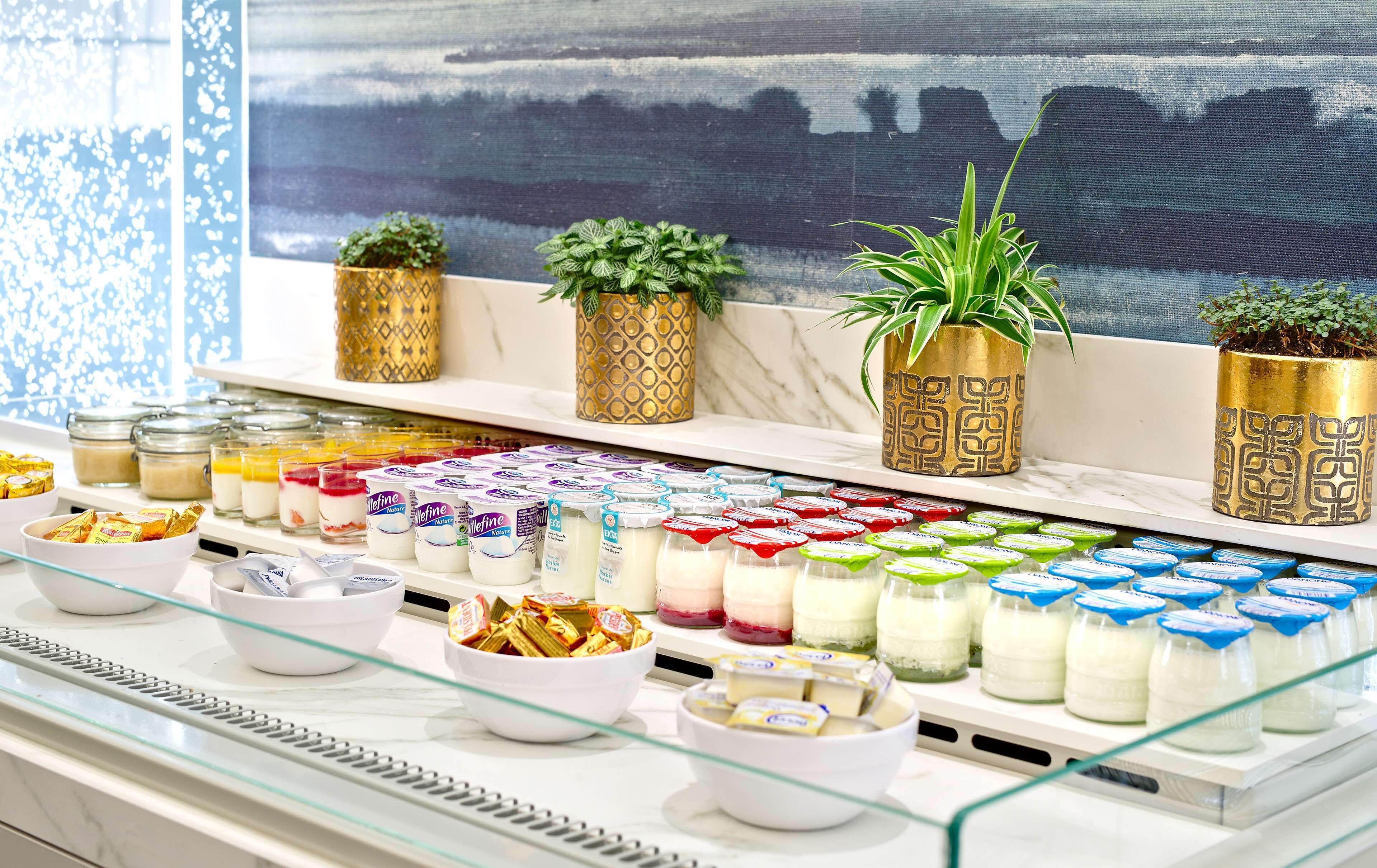 A display of dairy products including yogurt and cheese in a store.