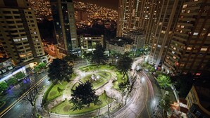 A nighttime cityscape with a roundabout and surrounding buildings. - Ritz Apart Hotel (La Paz)