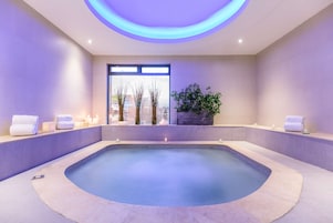 Un área de spa con hidromasaje, velas y toallas.