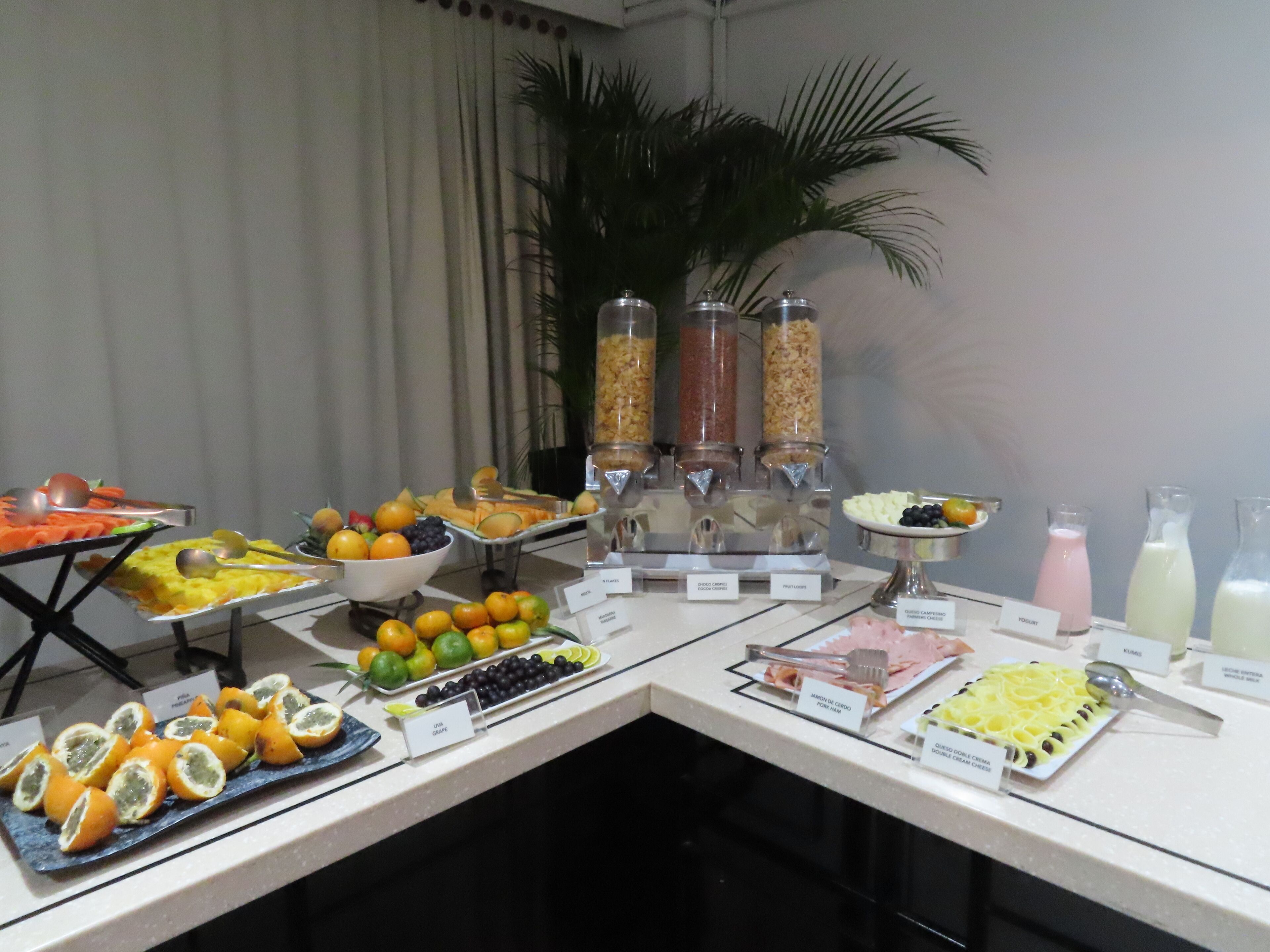 A buffet table with various food items and beverages.