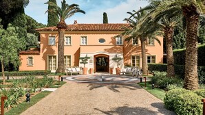 A two-story building with a tiled roof, a central entrance, and a paved driveway leading to the entrance. - La Bastide de Saint Tropez (Saint-Tropez)