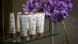Three bottles of bath gel and conditioner on a glass shelf. - Silka Seaview (Kowloon)
