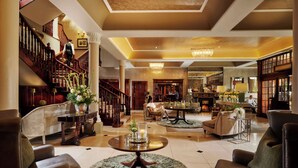 A spacious lobby with a grand staircase, comfortable seating areas, and a well-lit ambiance. - Hayfield Manor (Cork)