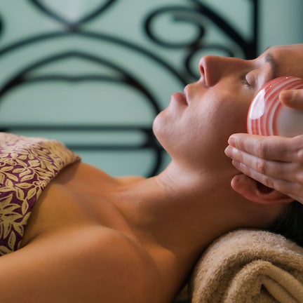 A person lying down with a patterned garment and a towel.