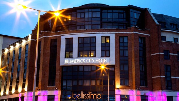 The Limerick City Hotel with a prominent sign, multiple windows, and a modern architectural design.