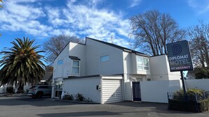 A modern white building with a sign for the Diplomat Motel stating no vacancy. - Diplomat Motel (Christchurch)