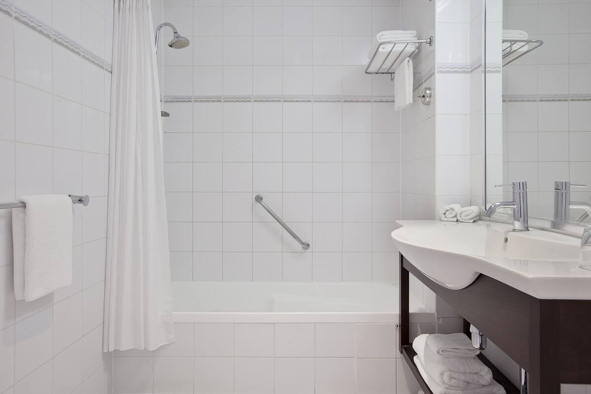 combined shower/bathtub, eco-friendly toiletries, hair dryer, bathrobes
